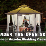 Bride under wooden wedding gazebo with floral decorations.