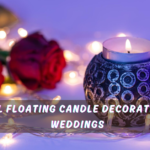 Romantic wedding table setup with floating candles in glass vases surrounded by rose petals and greenery, creating an elegant and glowing centerpiece ambiance.