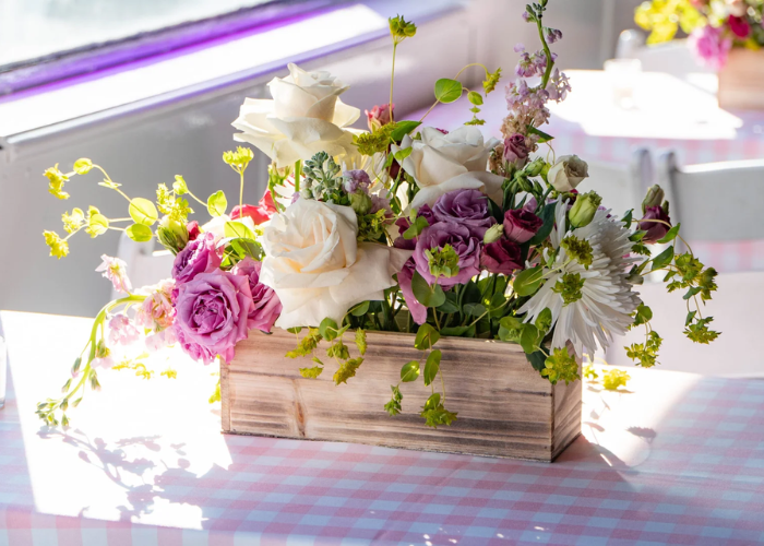 Elegant greenery runner with eucalyptus and candles as part of inexpensive wedding table decoration ideas for a natural, magazine-worthy setup.