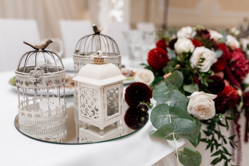 Budget-friendly indoor wedding decorations with faux floral garlands and candle clusters