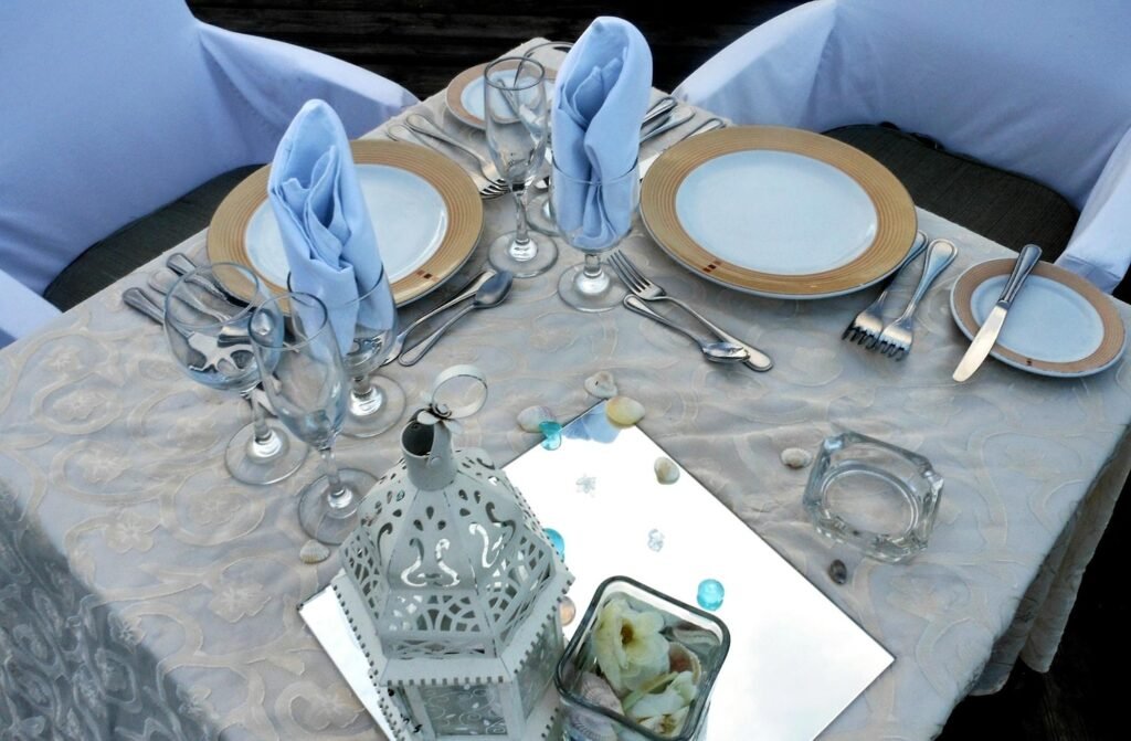 Elegant silver table settings for weddings with charger plates, silver cutlery, floral centerpieces, and sequin tablecloth styled in classic, modern, and rustic themes