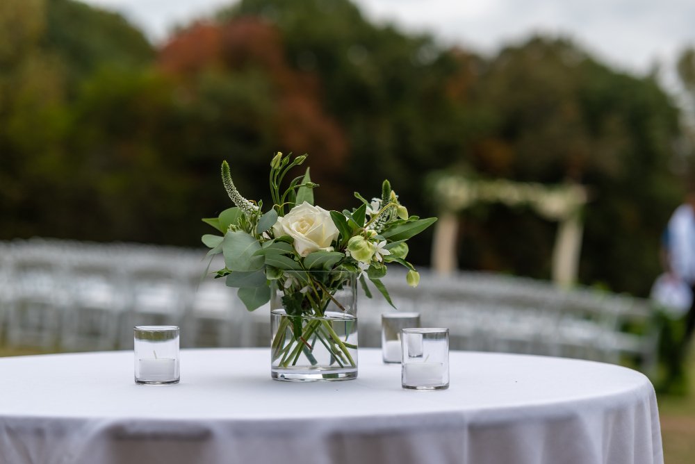 Modern indoor wedding ceremony decor with geometric arch.