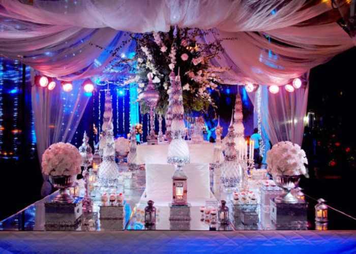 Elegant crystal centerpieces for weddings with candles and floral arrangements on dining tables.