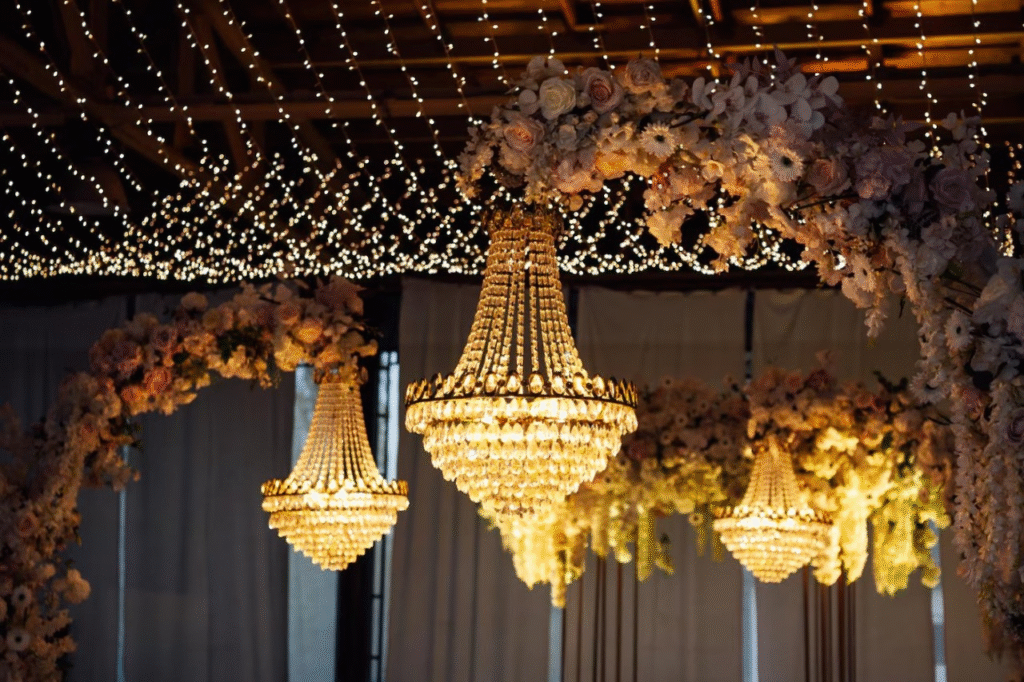 Wedding ballroom ceiling featuring elegant draping paired with hanging floral installations and ambient lighting, creating a magical, romantic atmosphere Wedding ballroom ceiling featuring elegant draping paired with hanging floral installations and ambient lighting, creating a magical, romantic atmosphere